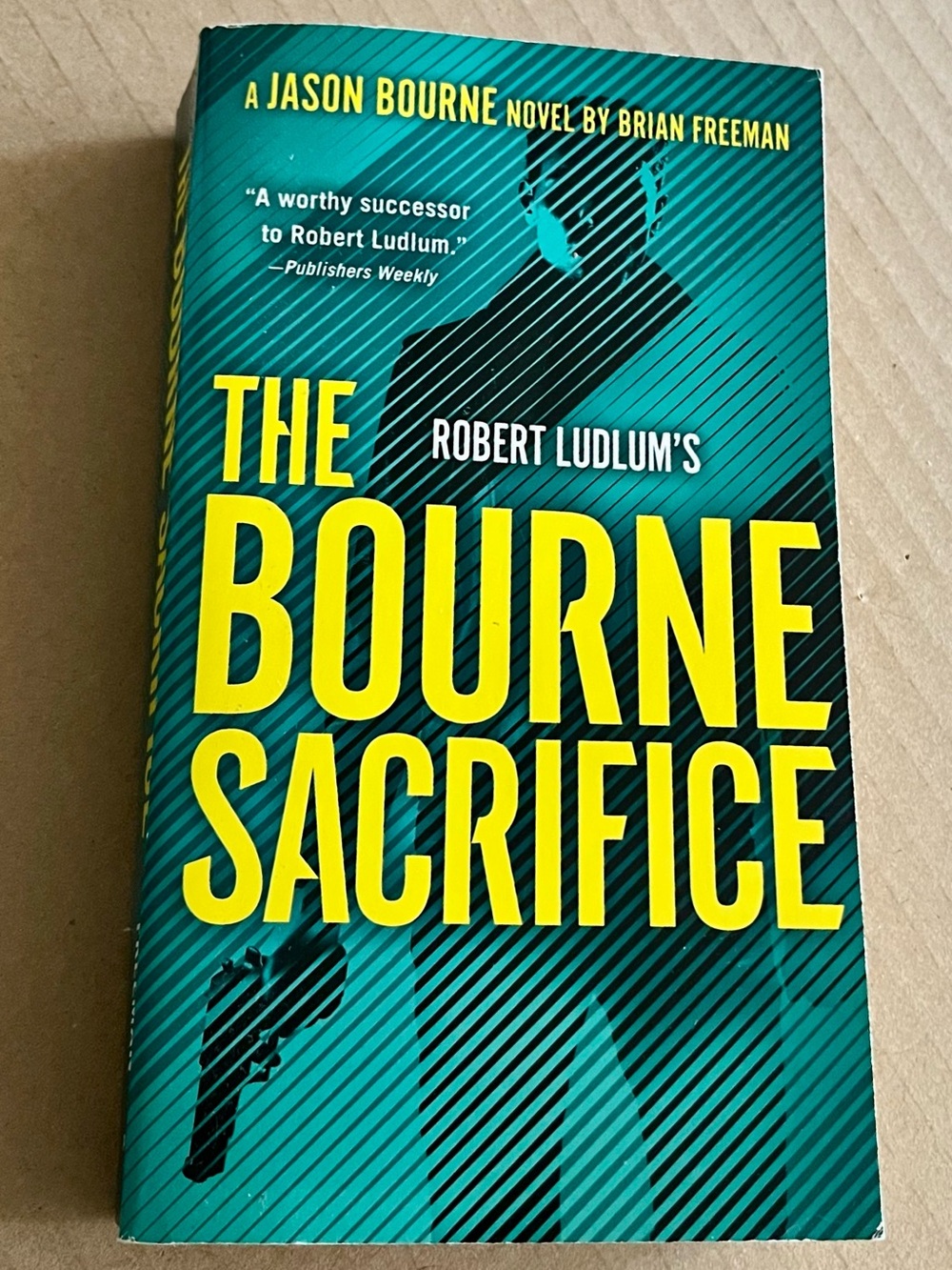 Robert Ludlum's The Bourne Sacrifice - Teal & Yellow Paperback